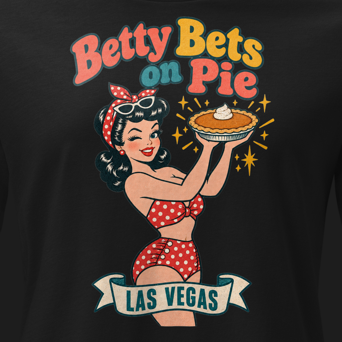 Betty Bets on Pie Relaxed T-Shirt in Black, close-up of the front print, Downtown Betty in a polka dot swimsuit holds up a pumpkin pie like a jackpot and winks