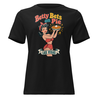 Betty Bets on Pie Relaxed T-Shirt in Black, front view, Downtown Betty in a polka dot swimsuit holds up a pumpkin pie like a jackpot and winks
