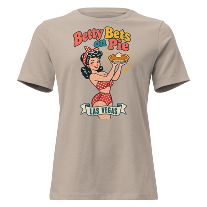 Betty Bets on Pie Relaxed T-Shirt in Heather Stone, front view, Downtown Betty in a polka dot swimsuit holds up a pumpkin pie like a jackpot and winks