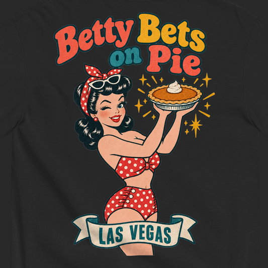 Betty Bets on Pie T-Shirt in Black, close-up of the back print, Downtown Betty in a polka dot swimsuit holds up a pumpkin pie like a jackpot and winks