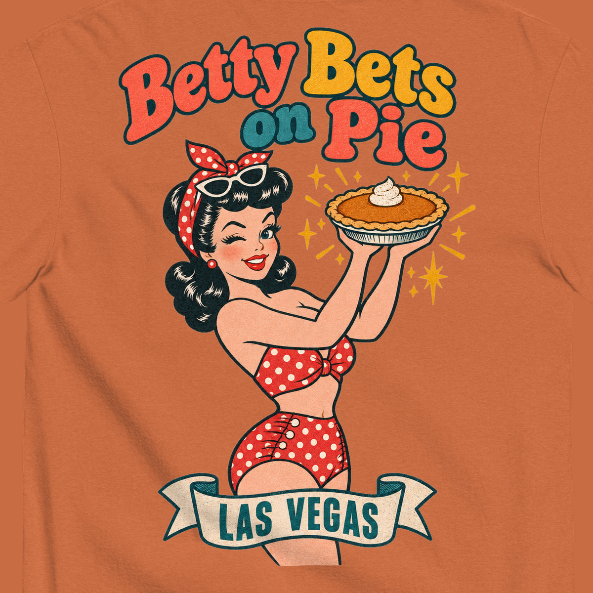 Betty Bets on Pie T-Shirt in Yam, close-up of the back print, Downtown Betty in a polka dot swimsuit holds up a pumpkin pie like a jackpot and winks