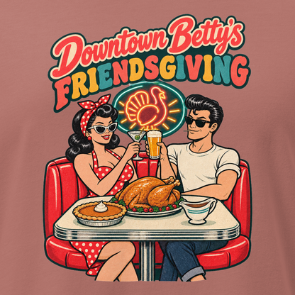Downtown Betty's Friendsgiving Relaxed T-Shirt in Mauve, close-up of the front print, Downtown Betty and Fremont Frank toast over a turkey dinner in a retro diner booth