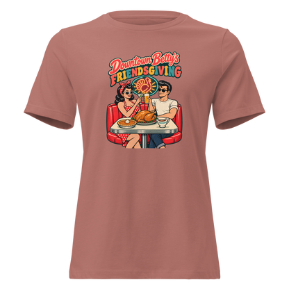 Downtown Betty's Friendsgiving Relaxed T-Shirt in Mauve, front view, Downtown Betty and Fremont Frank toast over a turkey dinner in a retro diner booth