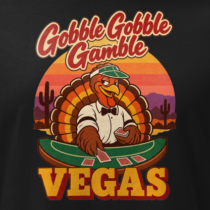 Gobble Gobble Gamble Relaxed T-Shirt in Black, close-up of the front print, a turkey in a green dealer visor deals blackjack at a felt table under a desert sunset