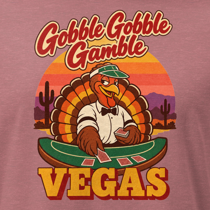 Gobble Gobble Gamble Relaxed T-Shirt in Heather Mauve, close-up of the front print, a turkey in a green dealer visor deals blackjack at a felt table under a desert sunset