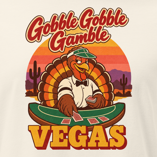 Gobble Gobble Gamble Relaxed T-Shirt in Natural, close-up of the front print, a turkey in a green dealer visor deals blackjack at a felt table under a desert sunset
