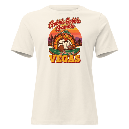 Gobble Gobble Gamble Relaxed T-Shirt in Natural, front view, a turkey in a green dealer visor deals blackjack at a felt table under a desert sunset