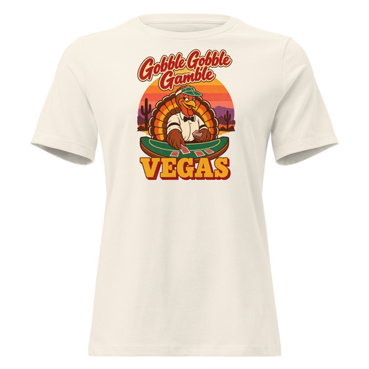 Gobble Gobble Gamble Relaxed T-Shirt in Natural, front view, a turkey in a green dealer visor deals blackjack at a felt table under a desert sunset