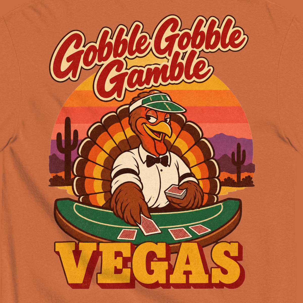 Gobble Gobble Gamble T-Shirt in Yam, close-up of the back print, a turkey in a green dealer visor deals blackjack at a felt table under a desert sunset
