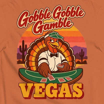 Gobble Gobble Gamble T-Shirt in Yam, close-up of the back print, a turkey in a green dealer visor deals blackjack at a felt table under a desert sunset