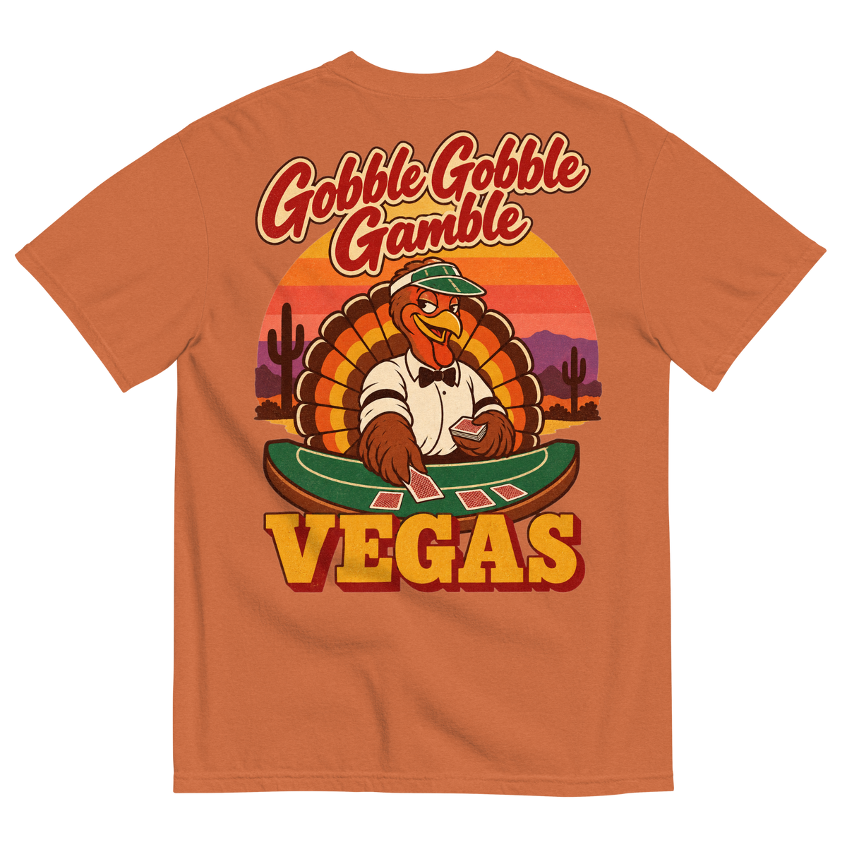 Gobble Gobble Gamble T-Shirt in Yam, back print, a turkey in a green dealer visor deals blackjack at a felt table under a desert sunset
