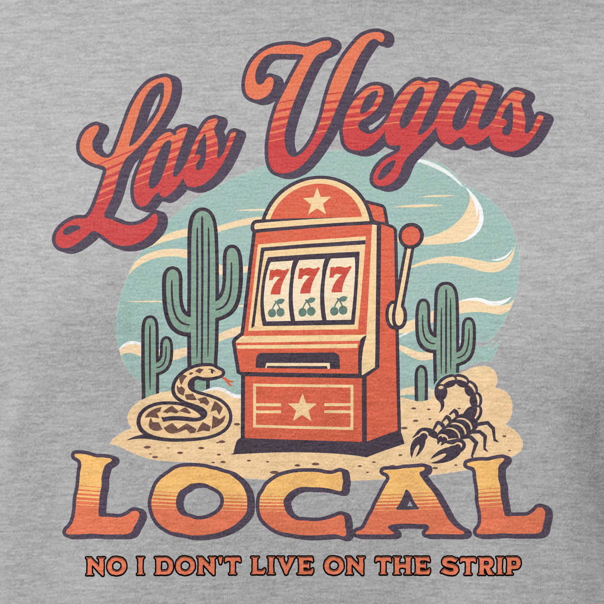 No I Don't Live On The Strip Relaxed T-Shirt in Athletic Heather, close-up of the front print, retro slot machine on triple 7s among saguaros with a rattlesnake and scorpion