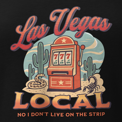 No I Don't Live On The Strip V-Neck in Solid Black Blend, close-up of the front print, retro slot machine on triple 7s among saguaros with a rattlesnake and scorpion