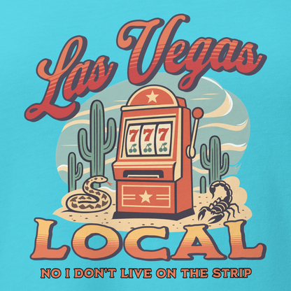 No I Don't Live On The Strip V-Neck in Turquoise, close-up of the front print, retro slot machine on triple 7s among saguaros with a rattlesnake and scorpion