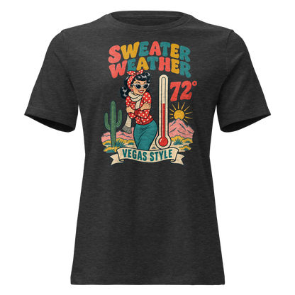 Sweater Weather Relaxed T-Shirt in Dark Grey Heather, front view, Downtown Betty shivering in a scarf beside a thermometer reading 72 degrees and a cactus