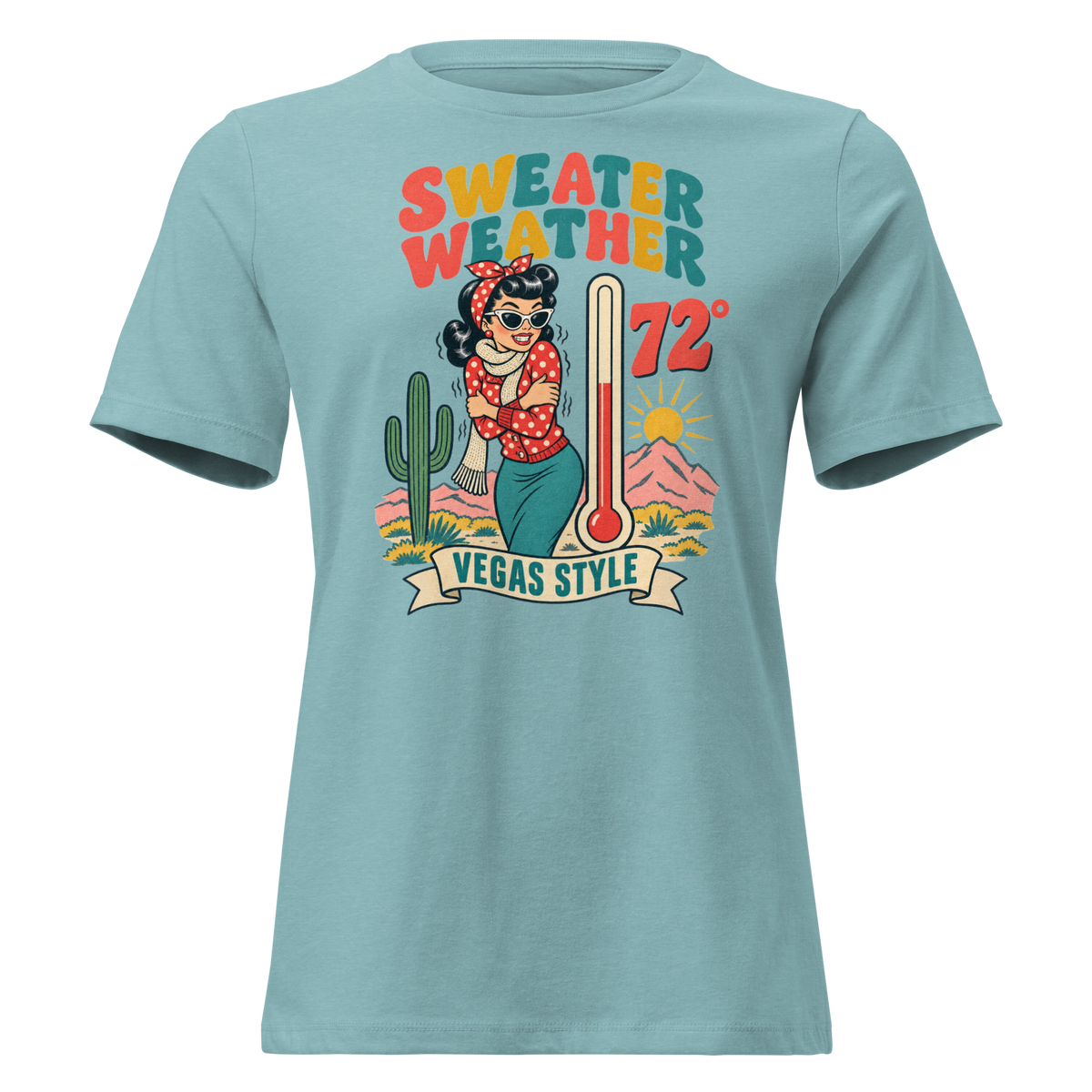 Sweater Weather Relaxed T-Shirt in Heather Blue Lagoon, front view, Downtown Betty shivering in a scarf beside a thermometer reading 72 degrees and a cactus