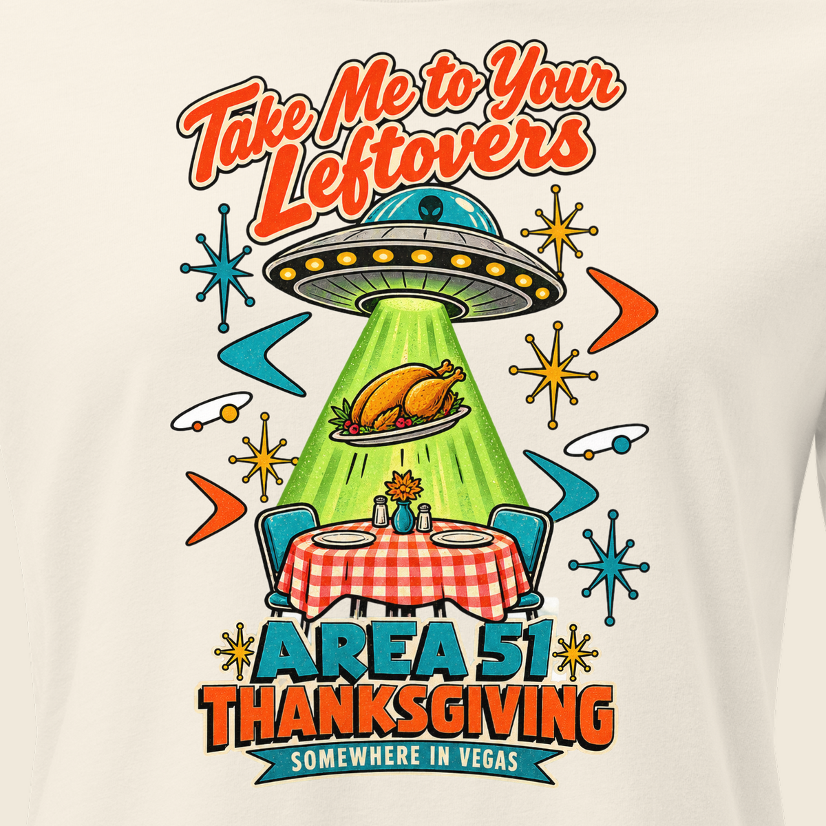 Take Me to Your Leftovers Relaxed T-Shirt in Natural, close-up of the front print, a flying saucer beams a roast turkey off a checkered 1950s table among atomic starbursts