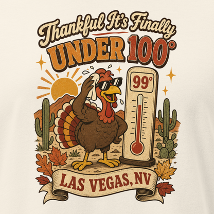 Thankful It's Finally Under 100 Relaxed T-Shirt in Natural, close-up of the front print, Turkey in sunglasses by a 99 degree thermometer, cactus and fall leaves