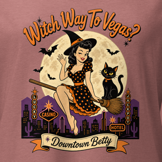 Witch Way To Vegas V-Neck in Heather Mauve, close-up of the front print, Downtown Betty pinup witch on a broom over a neon Vegas skyline