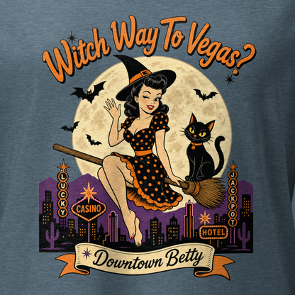 Witch Way To Vegas V-Neck in Heather Slate, close-up of the front print, Downtown Betty pinup witch on a broom over a neon Vegas skyline