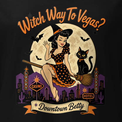 Witch Way To Vegas V-Neck in Solid Black Blend, close-up of the front print, Downtown Betty pinup witch on a broom over a neon Vegas skyline
