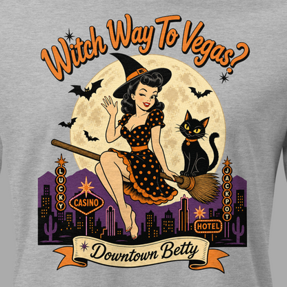 Witch Way To Vegas Relaxed T-Shirt in Athletic Heather, close-up of the front print, Downtown Betty pinup witch on a broom over neon Vegas